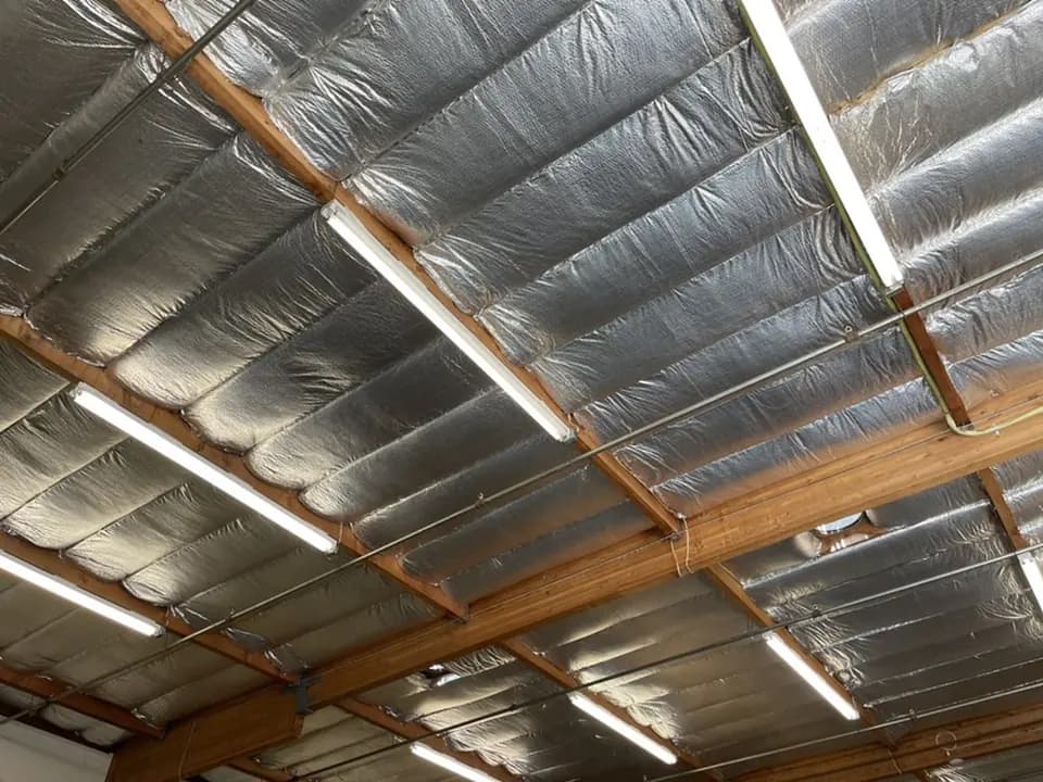 Foil radiant barrier stapled under attic rafters